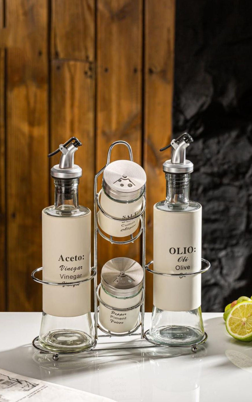 Set of glass condiment bottles with labels on a wooden surface